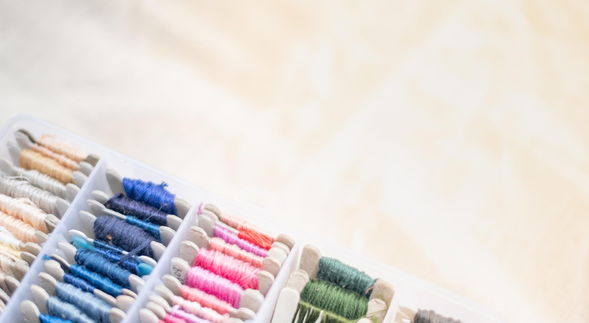 atelier workspace with embroidered samples and threads