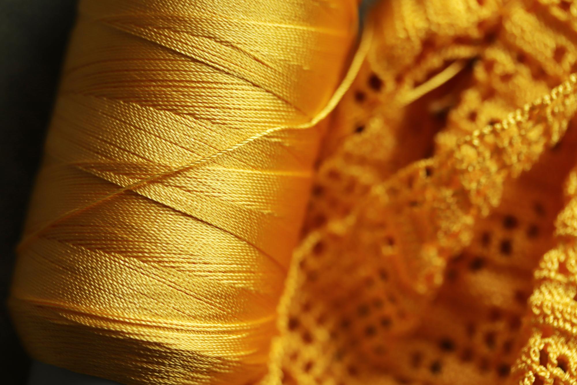 close-up of embroidered linen with gold thread